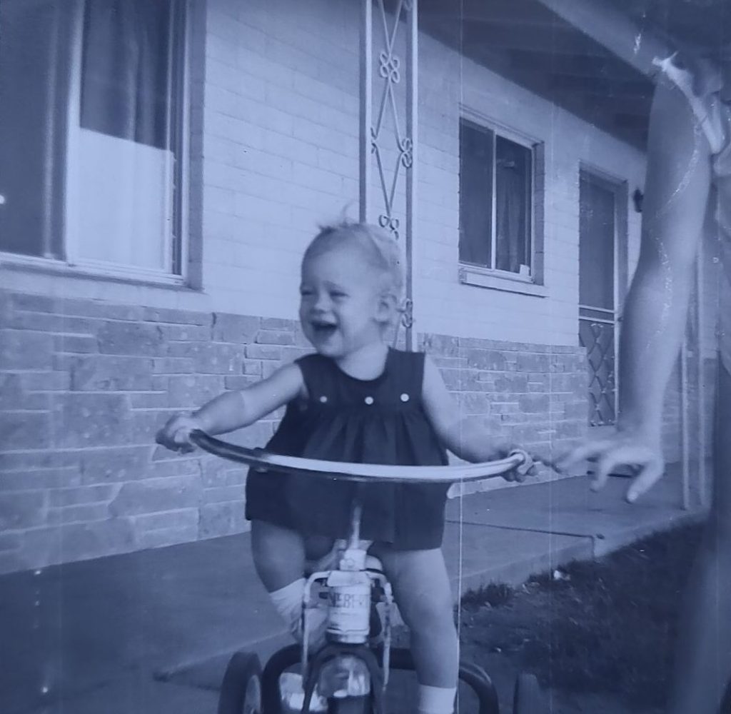 Shé on the move, early on, with a little help from her mum